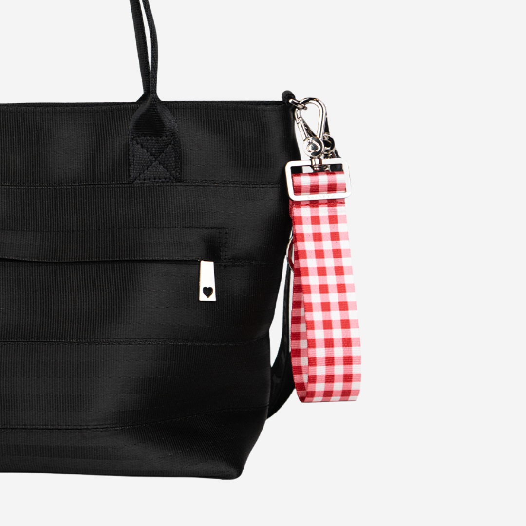 The 4 Panel Keychain in Red Gingham being used on a bag