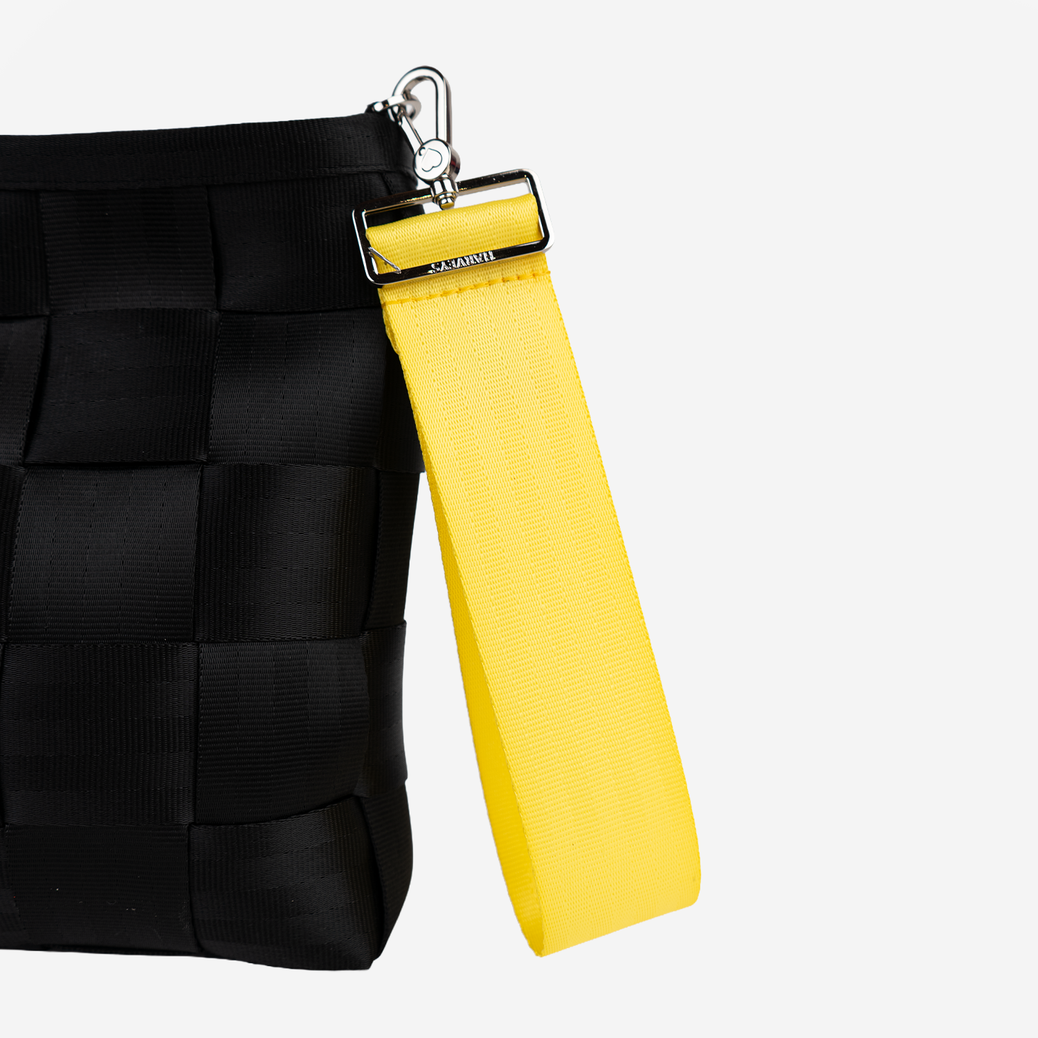 The 5 Panel Keychain in Lemon being used on a bag