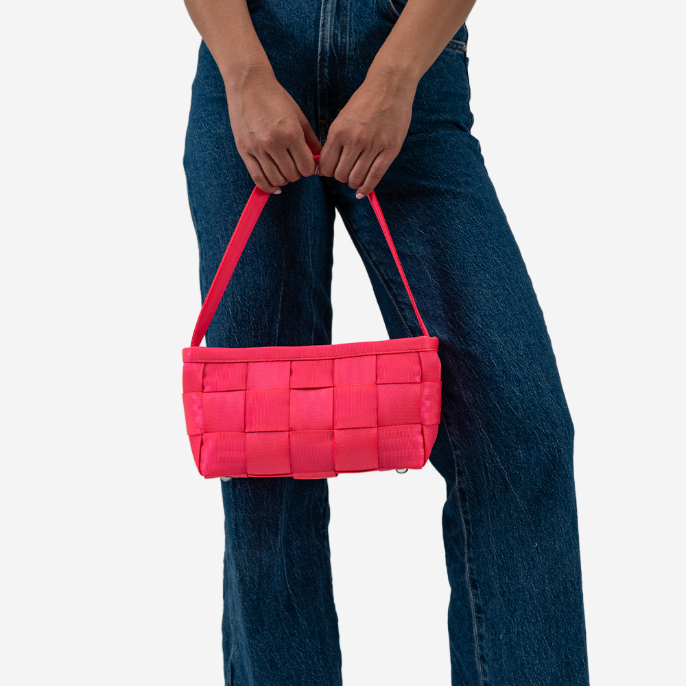 The Baguette in Dragonfruit being held by a model