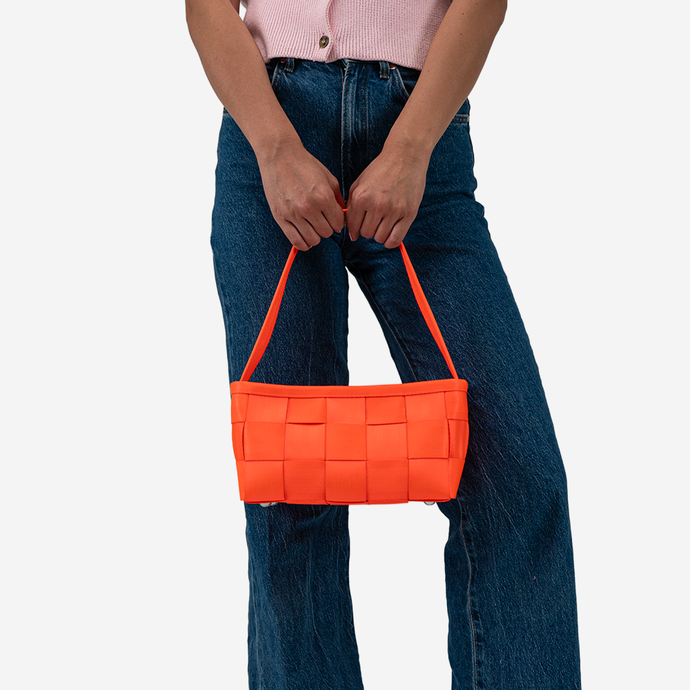 The Baguette in Poppy being held by a model