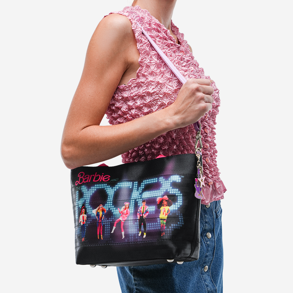 The Barbie And The Rockers Mini Streamline Tote being worn by a model
