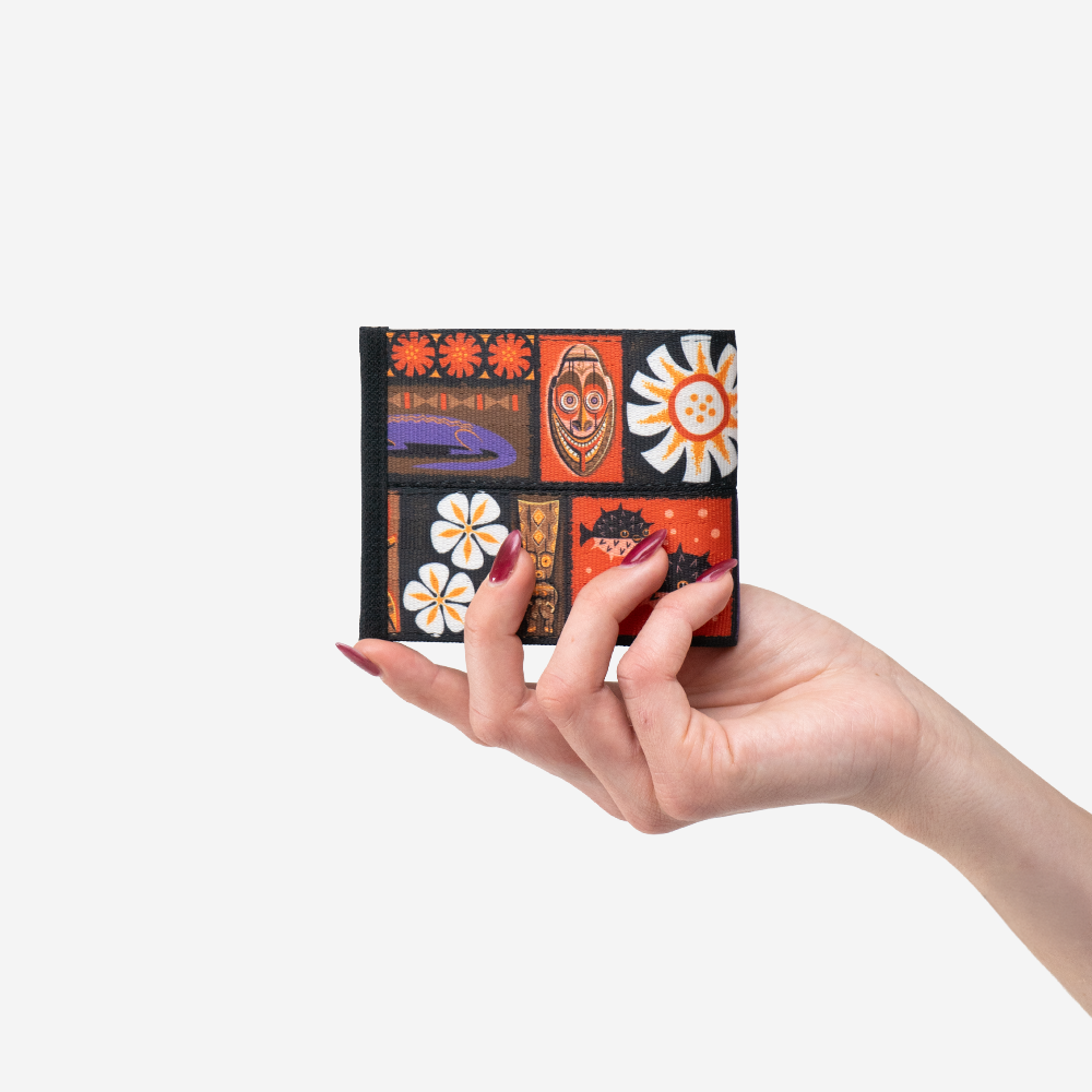 The Shag Tiki Tapa Billfold being held by a model
