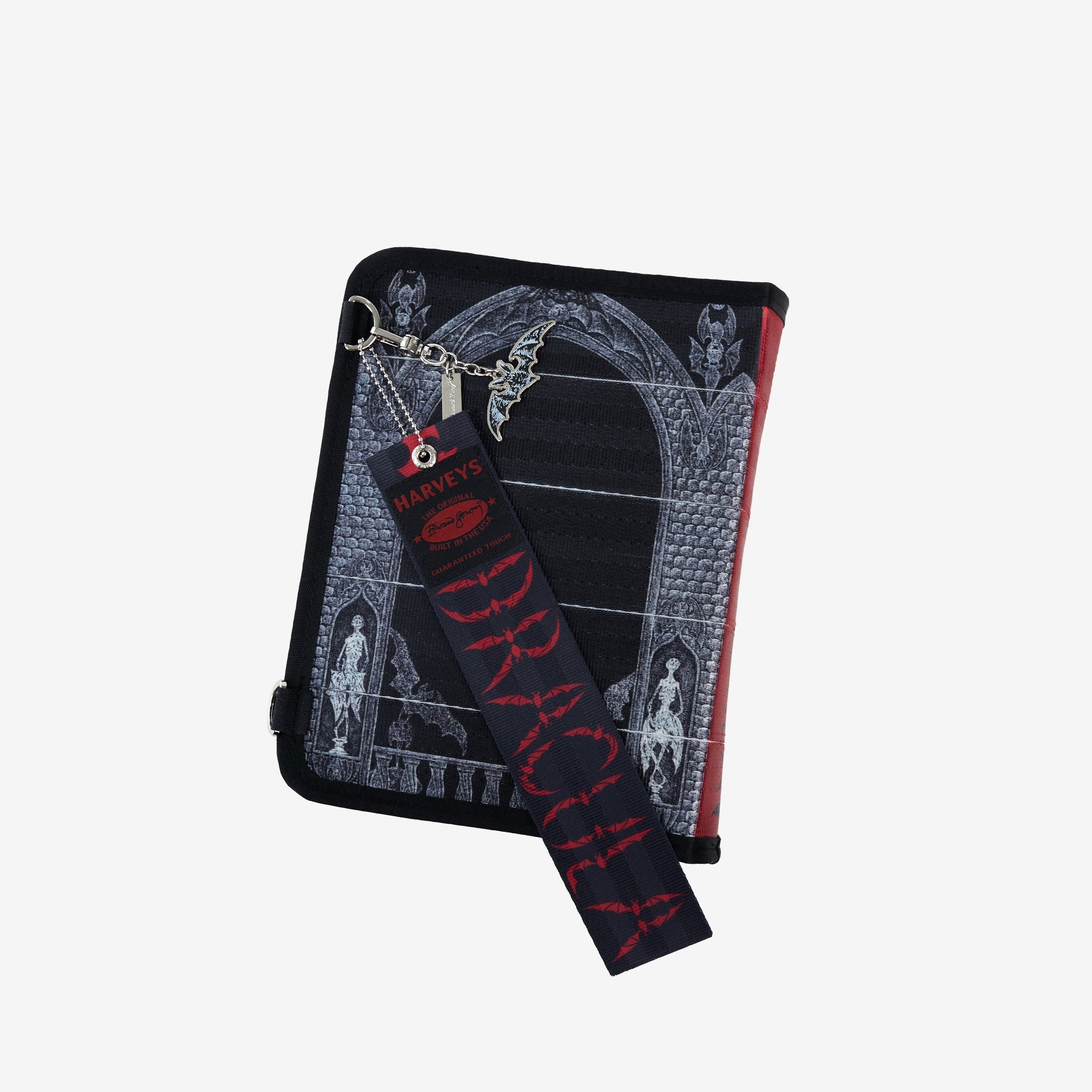 Back view of black crossbody bag with black Dracula strap draped across