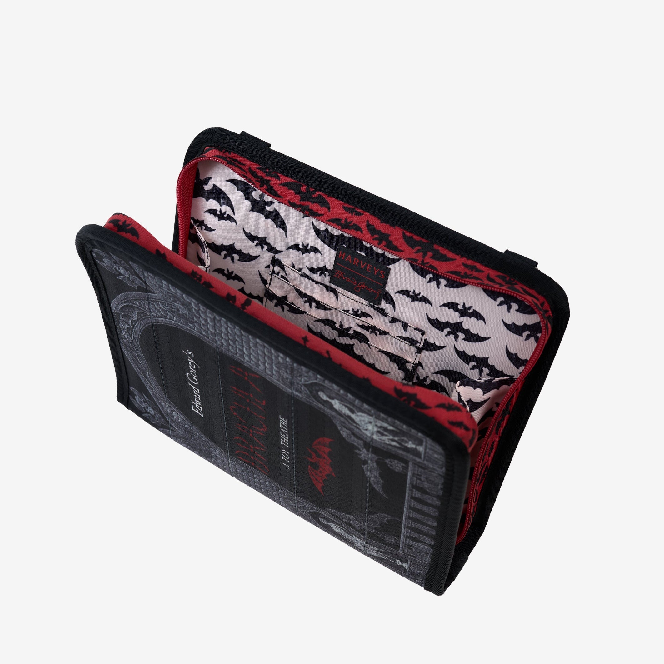 View of black crossbody bag unzipped displaying inside lining and slip pockets