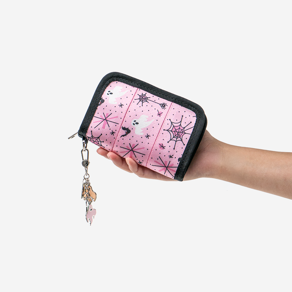 A Pink-A-Boo Fun Size Wallet being held in a models hand.