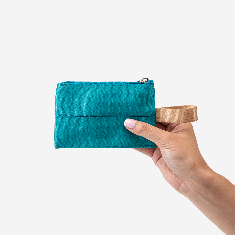 The Ice Pop Coin Purse in Aqua being held by a model