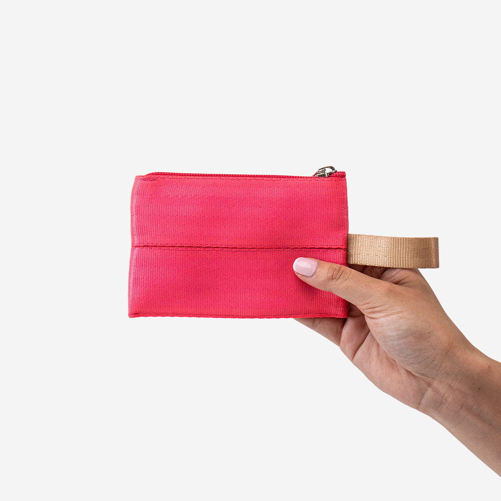 The Ice Pop Coin Purse in Dragonfruit being held by a model