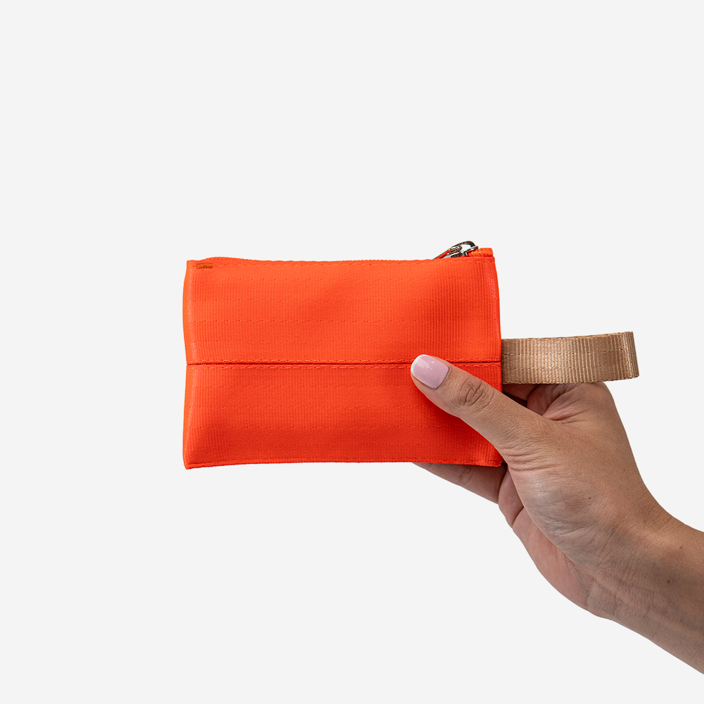 The Ice Pop Coin Purse in Poppy being held by a model