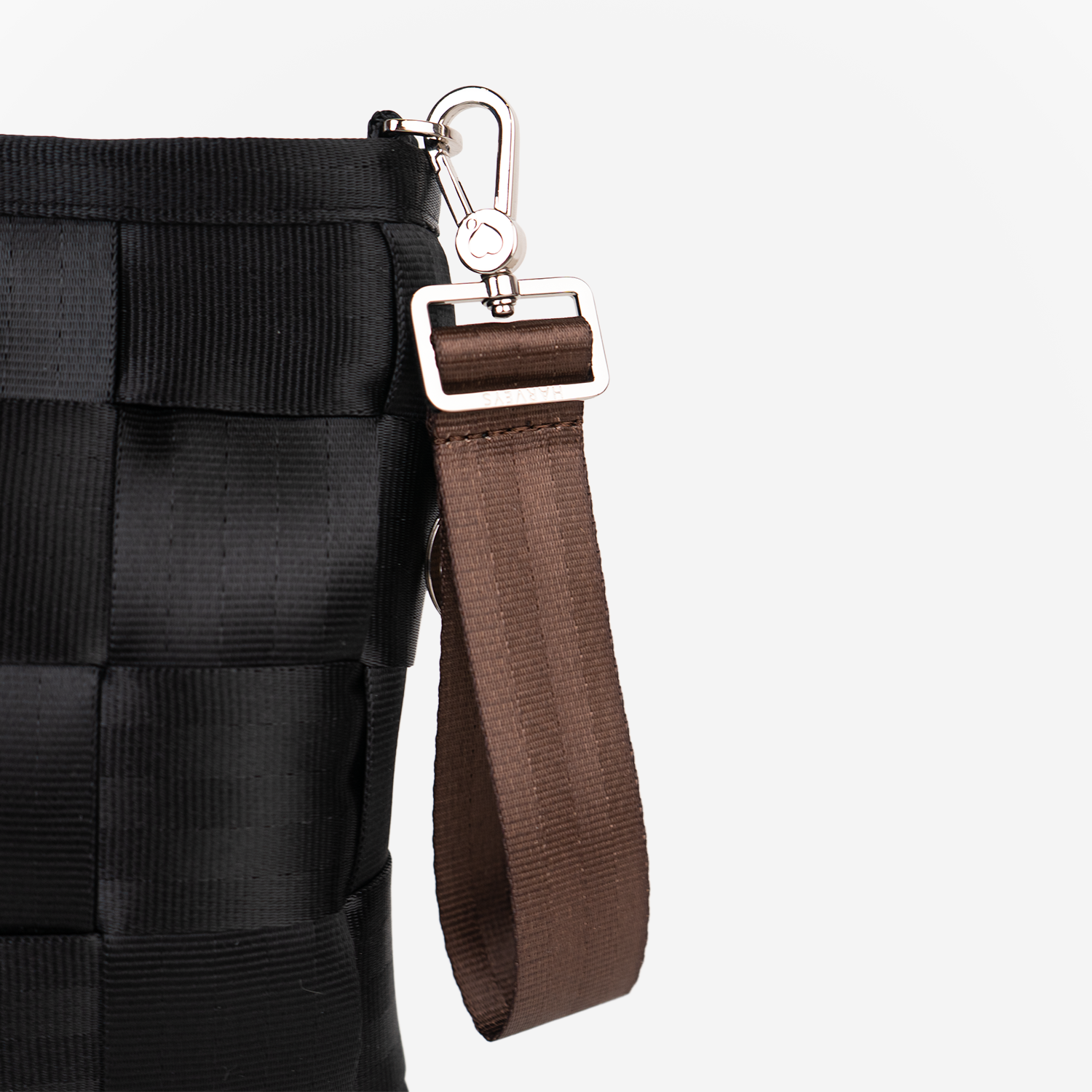 The 4 Panel Keychain in Espresso being used on a bag
