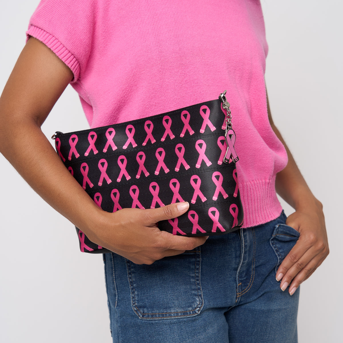 A model wearing The Pink Agenda Pink Ribbon Medium Convertible Clutch