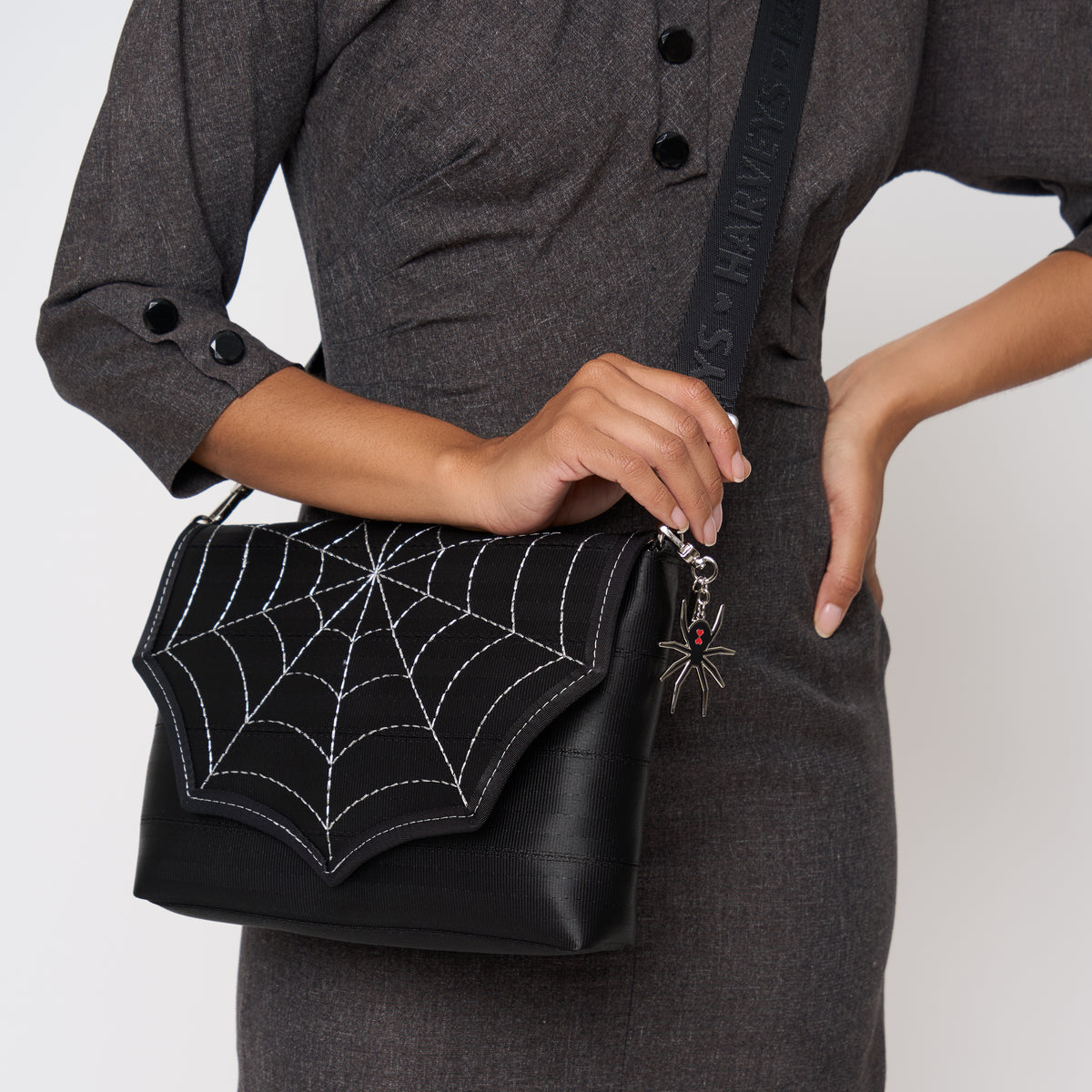 A model wearing a Black Widow Medium Foldover Crossbody Collector's Series