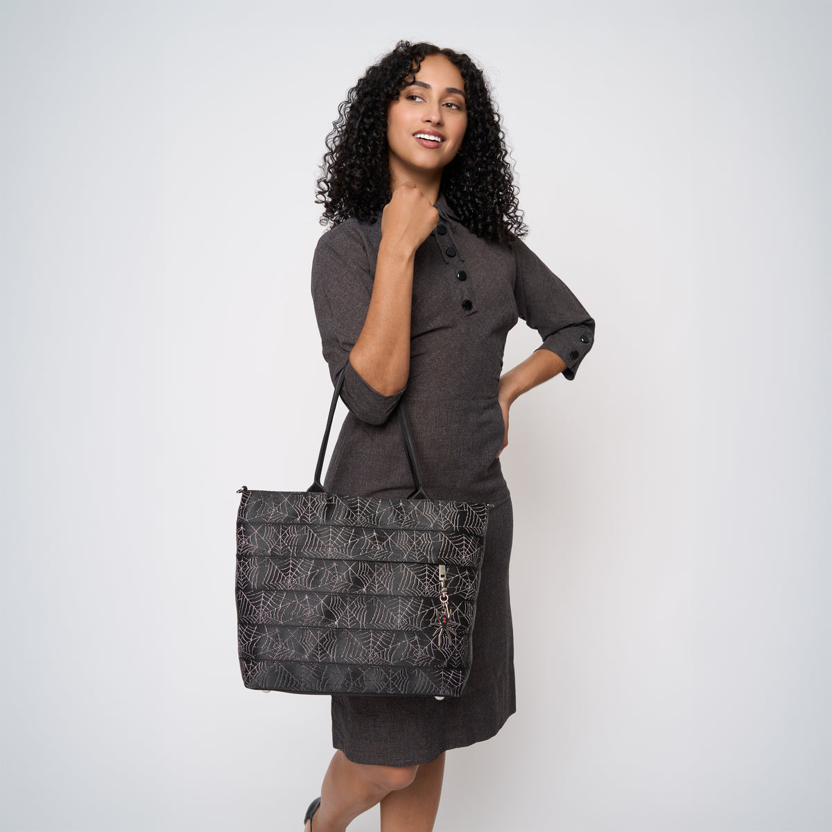 A model wearing a Black Widow Medium Streamline tote