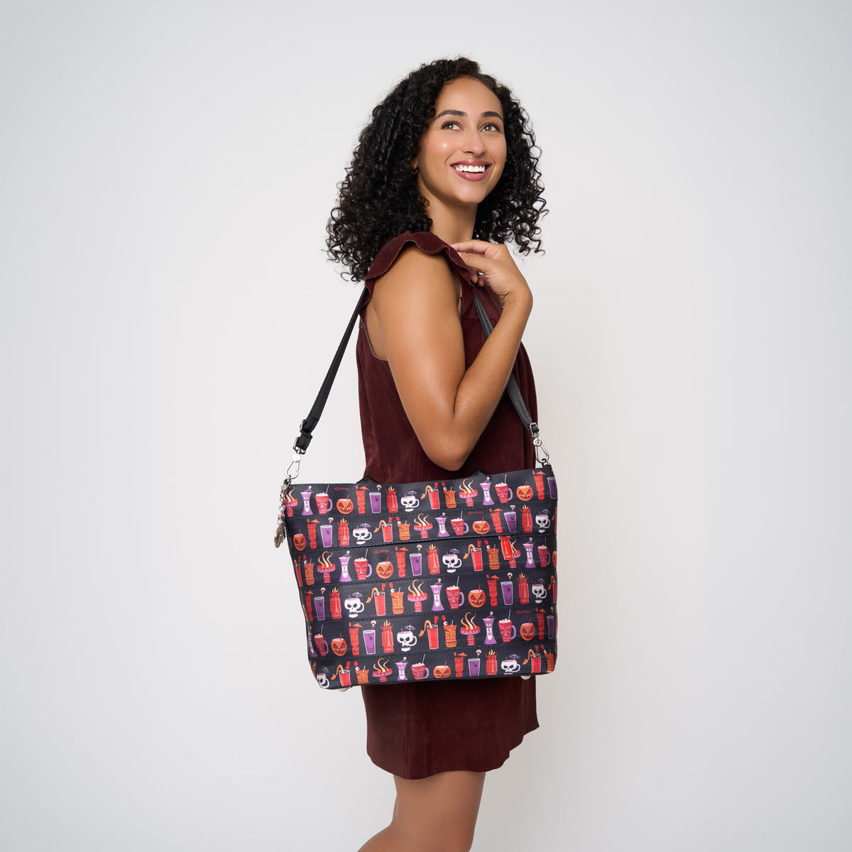 View of model using extendible strap to wear Medium Streamline Tote Shag Spooky Tiki Cocktail