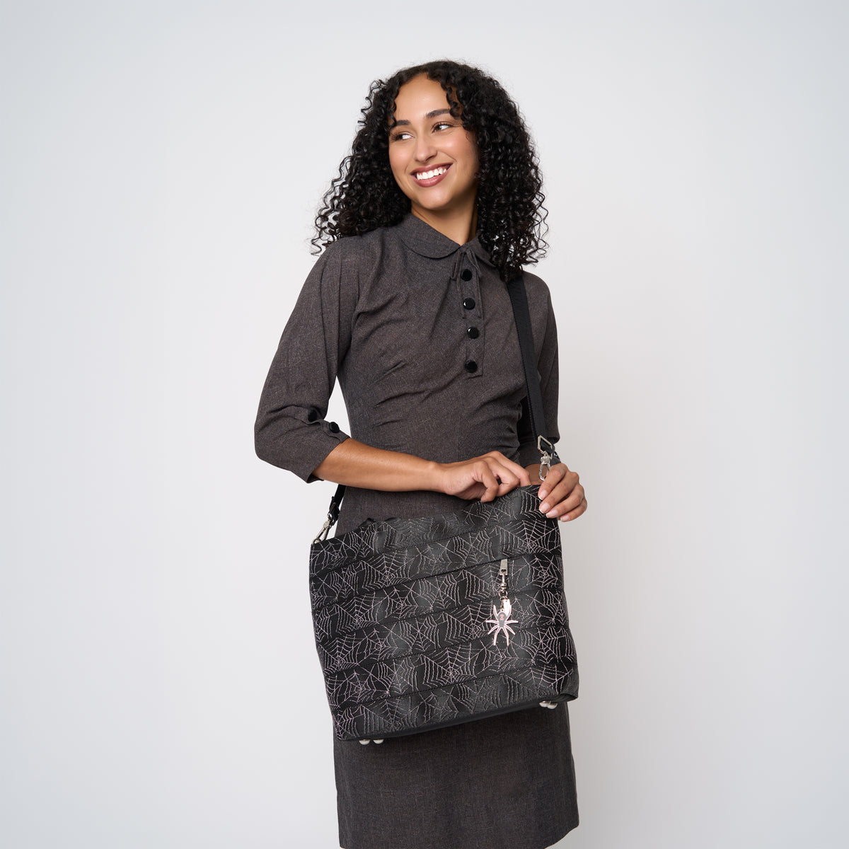A model wearing a Black Widow Medium Streamline tote