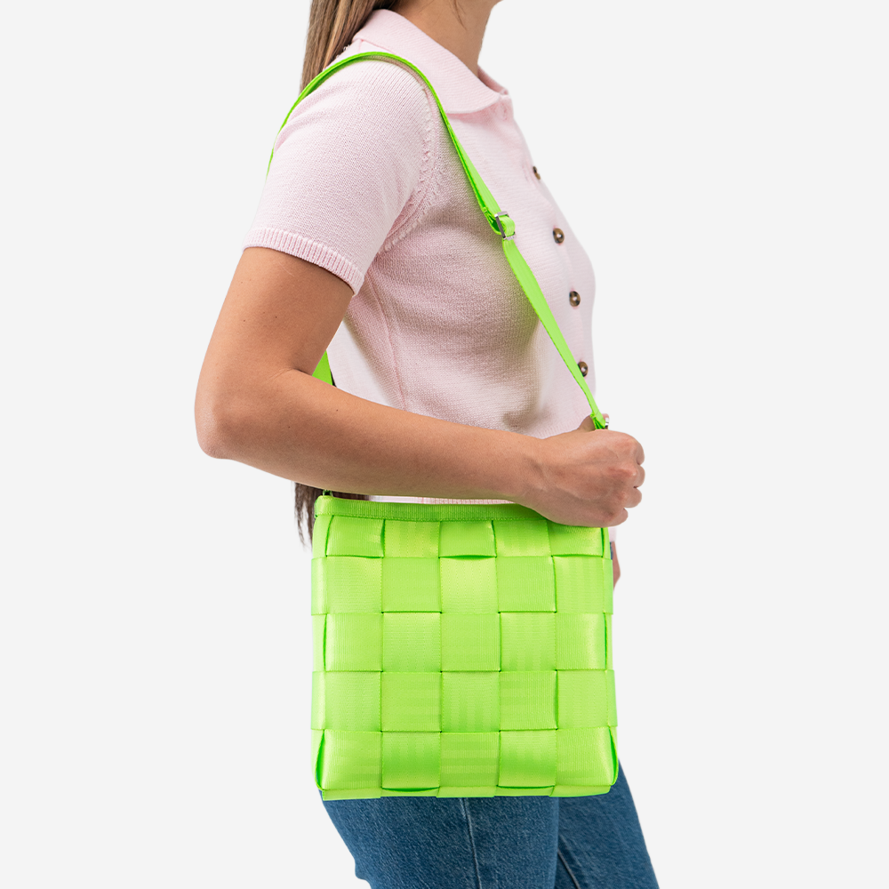 The Mini Messenger in Lime being worn by a model