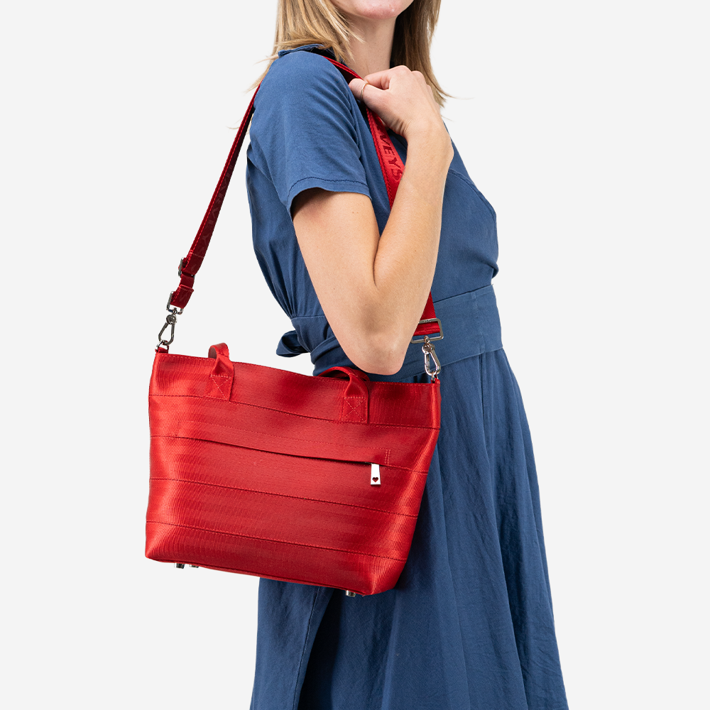 The Mini Streamline Tote in Scarlet being worn by a model