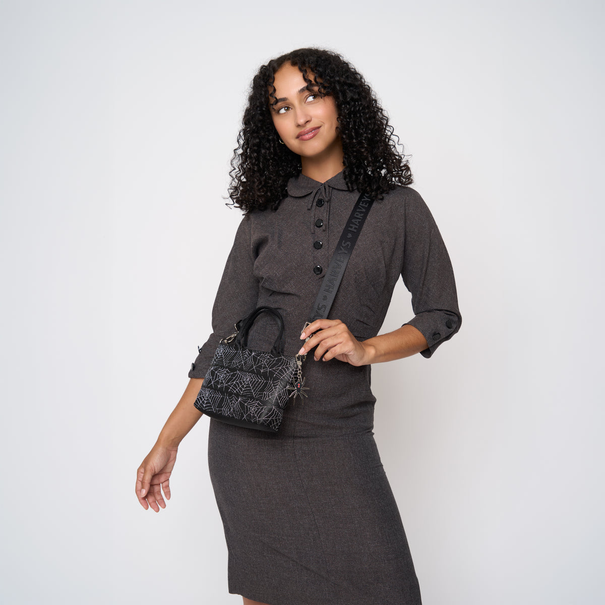 A model wearing a Black Widow Petite Tote