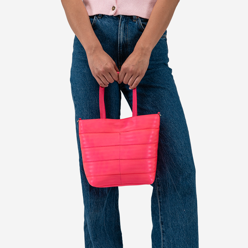 The Rosie Tote in Dragonfruit being held by a model