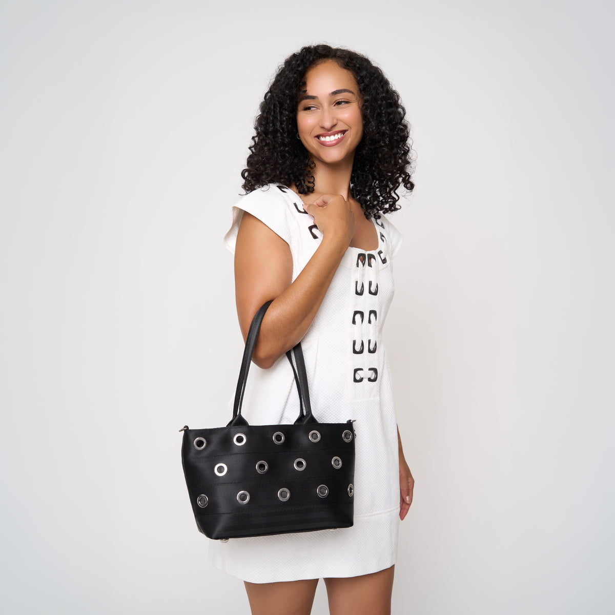 Model holding PUNK'N streamline baguette grommet on arm