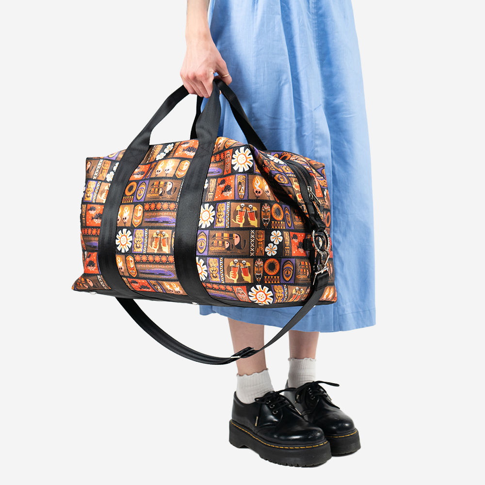 The Shag Tiki Tapa Weekender being held by a model
