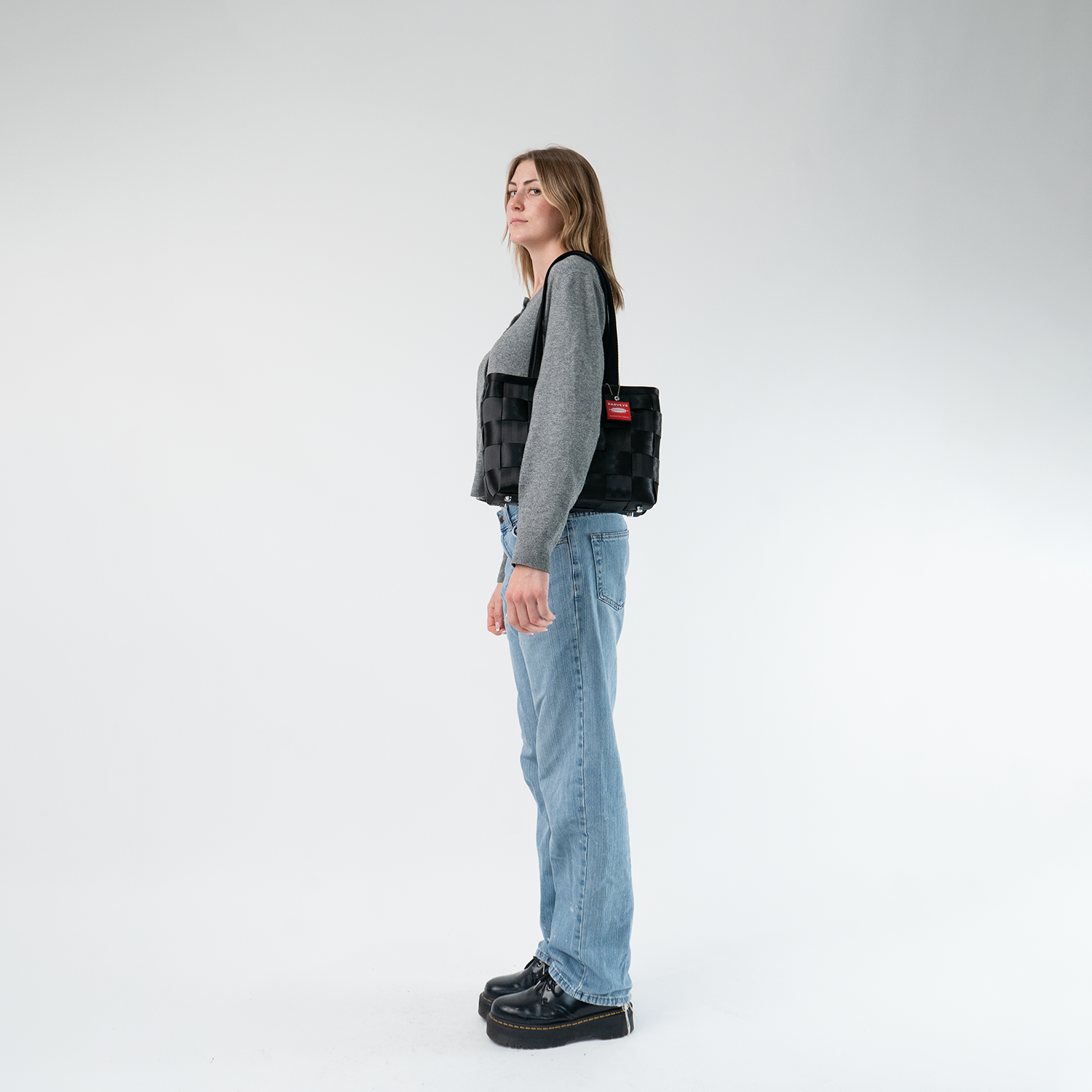 A Large Tote in Black on a model's shoulder