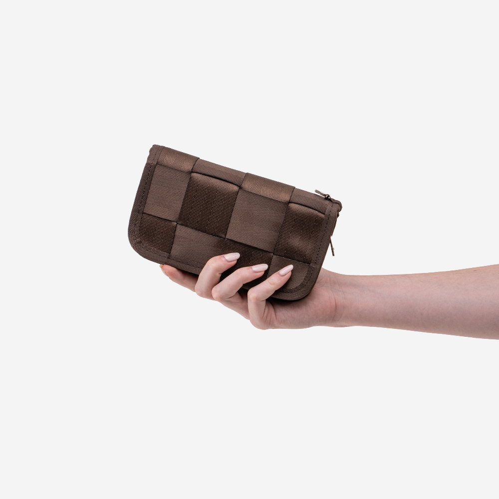 The Classic Wallet in Espresso being held by a model