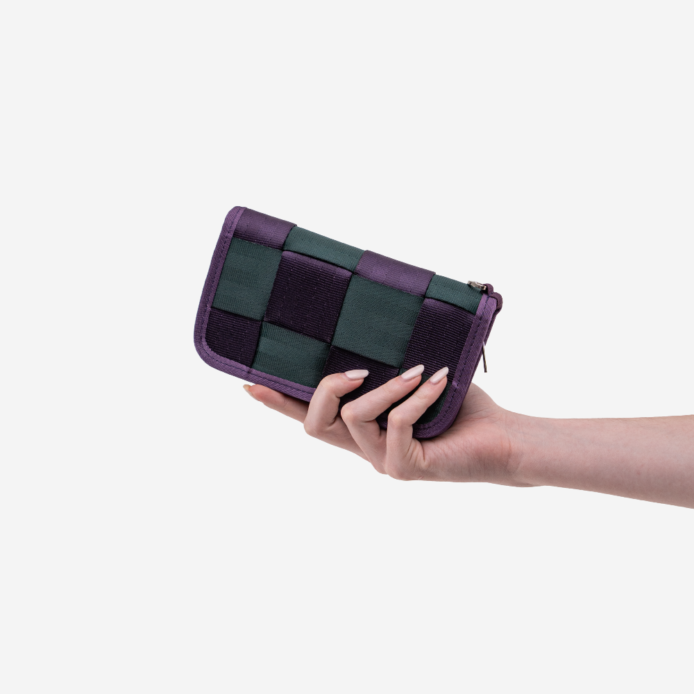 The Classic Wallet in Poison Ivy being held by a model
