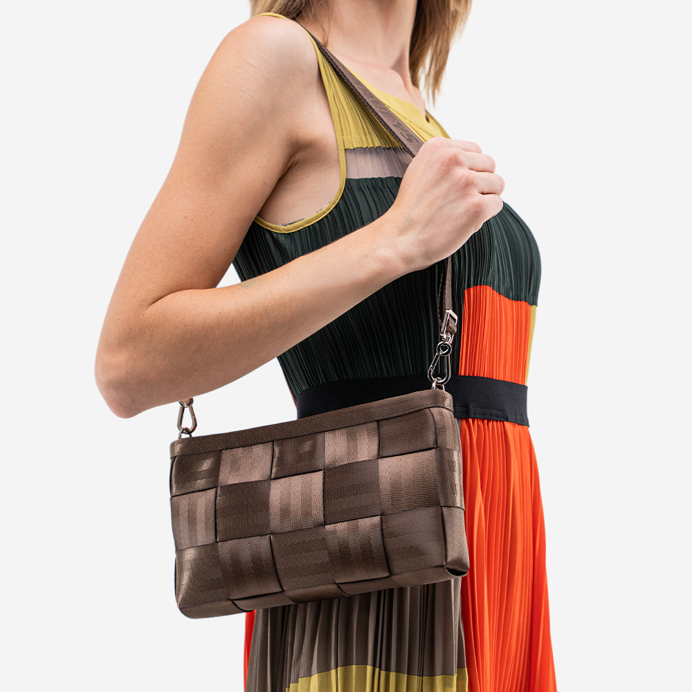 The Convertible Clutch in Espresso being worn by a model