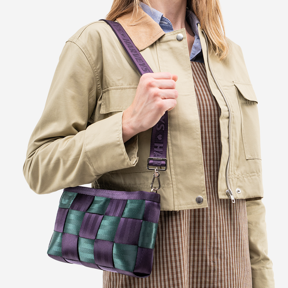 The Convertible Clutch in Poison Ivy being worn by a model