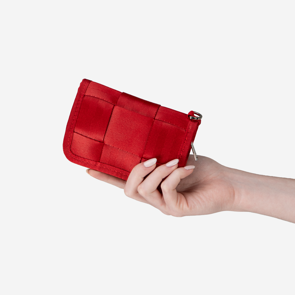 A Scarlet Fun Size Wallet being held in a models hand