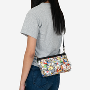 looney tunes convertible clutch being worn crossbody on a model