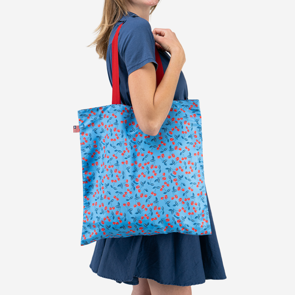 The Shopper Tote in American Cherry being worn by a model