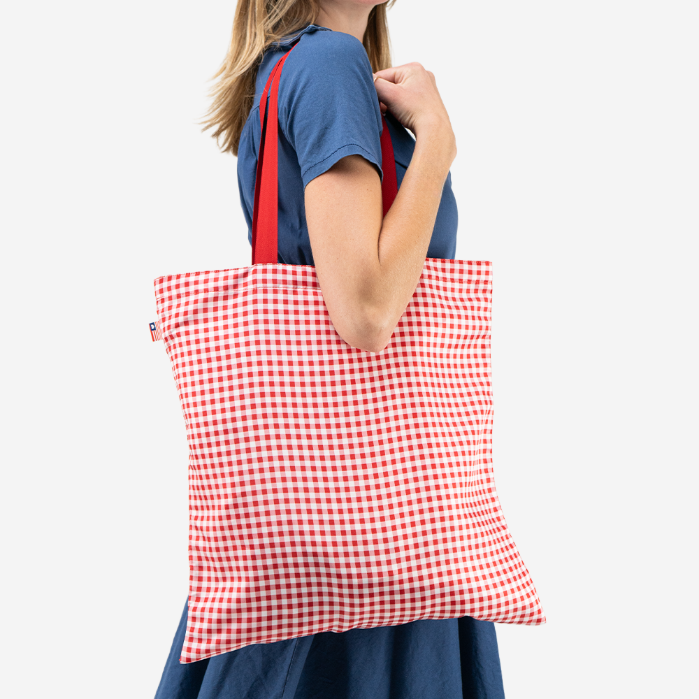 The Shopper Tote in Red Gingham being worn by a model