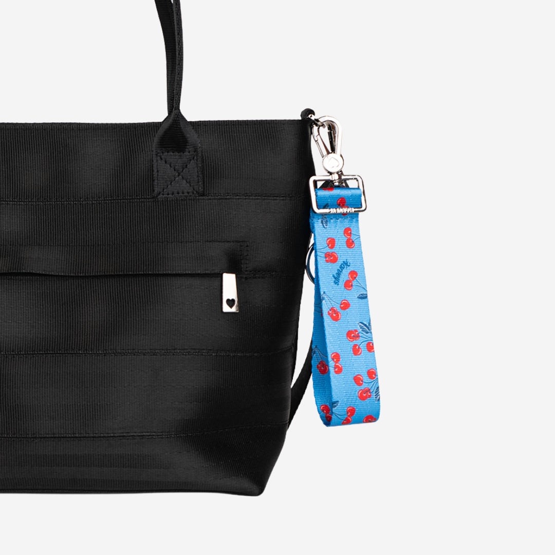 The American Cherry 4 Panel Keychain being used on a bag