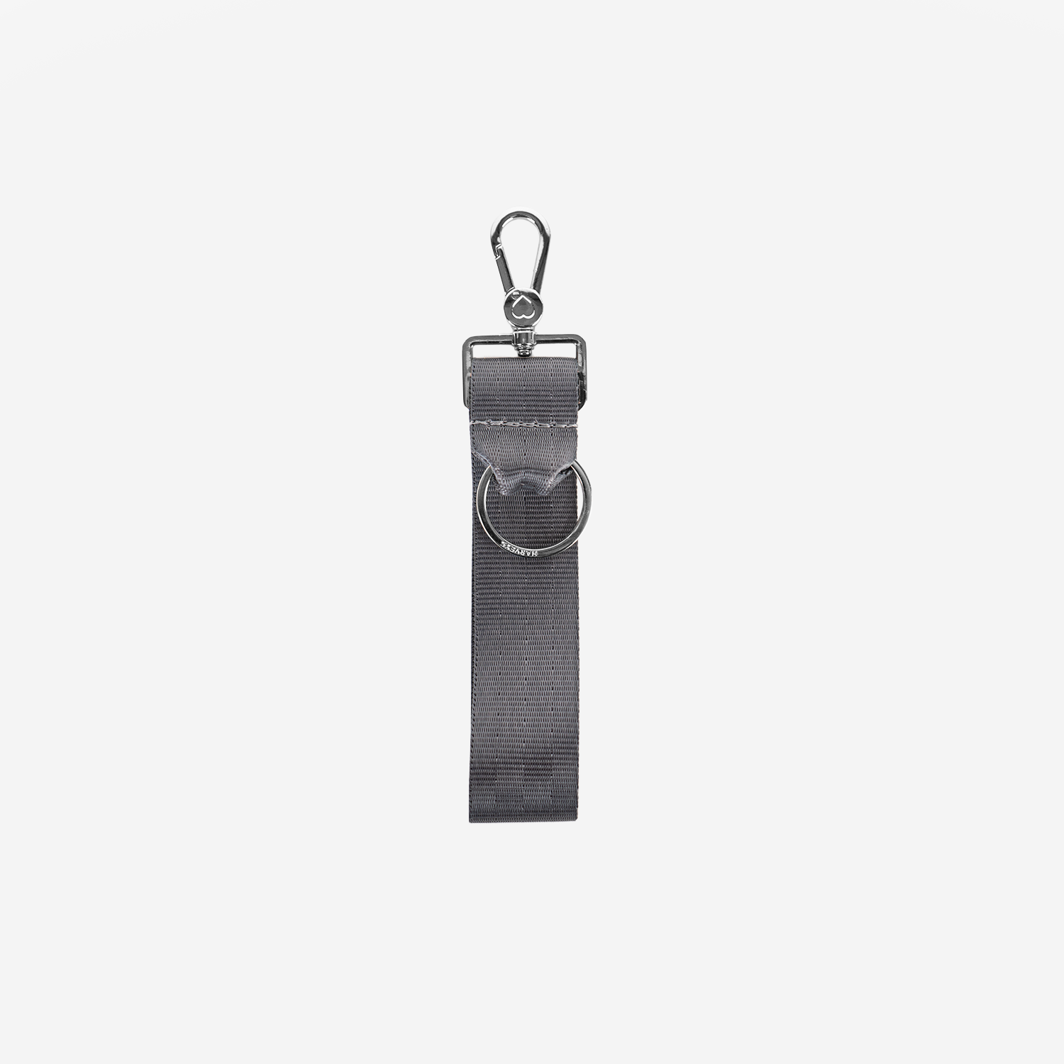 A dark gray seatbelt keychain with a silver metal swivel snap hook and a matching silver metal D-ring, shown against a plain light gray background.