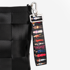 The Barbie Through The Eras 4 Panel Keychain being used on a bag