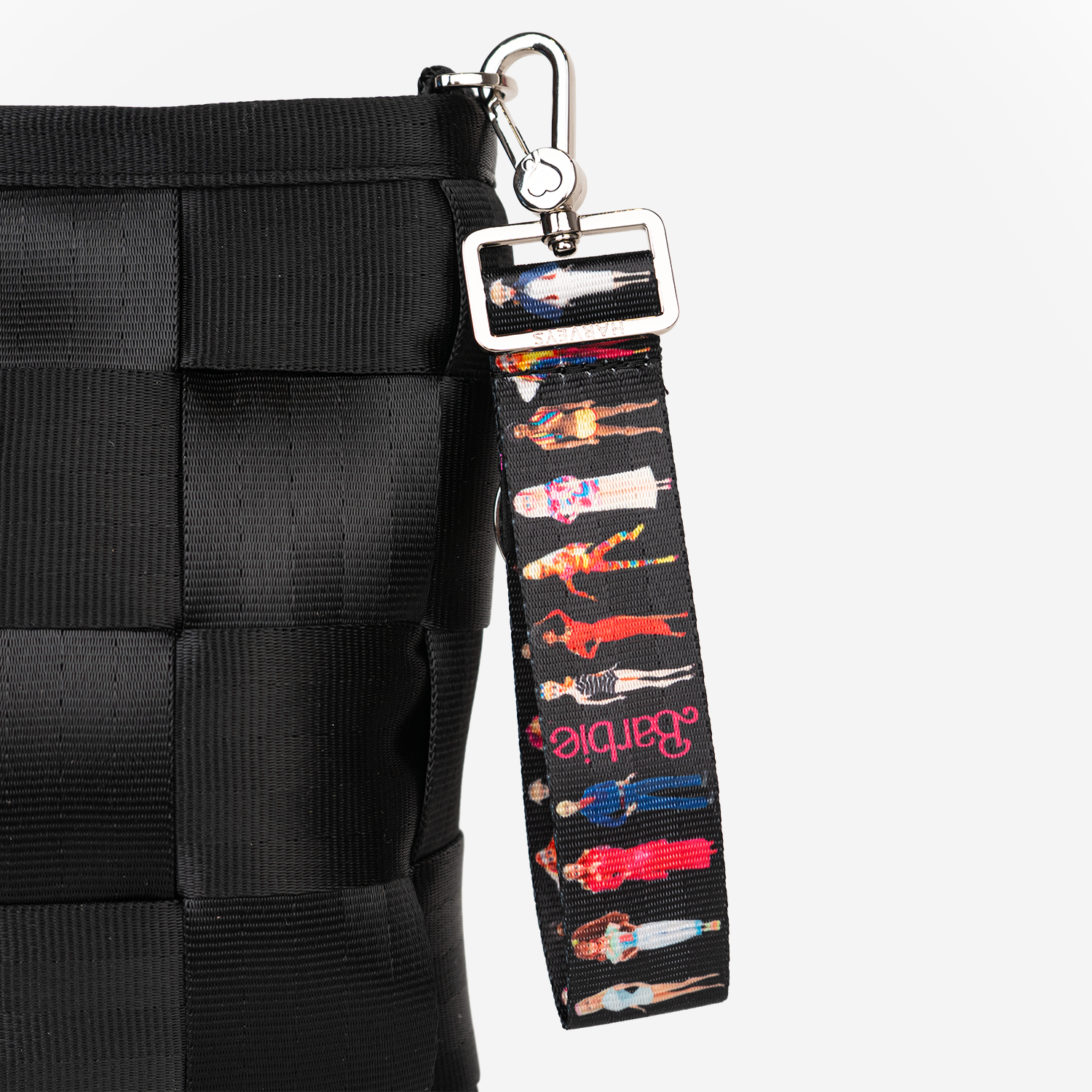 The Barbie Through The Eras 4 Panel Keychain being used on a bag
