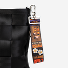The Shag Tiki Tapa 4 Panel Keychain being used on a bag