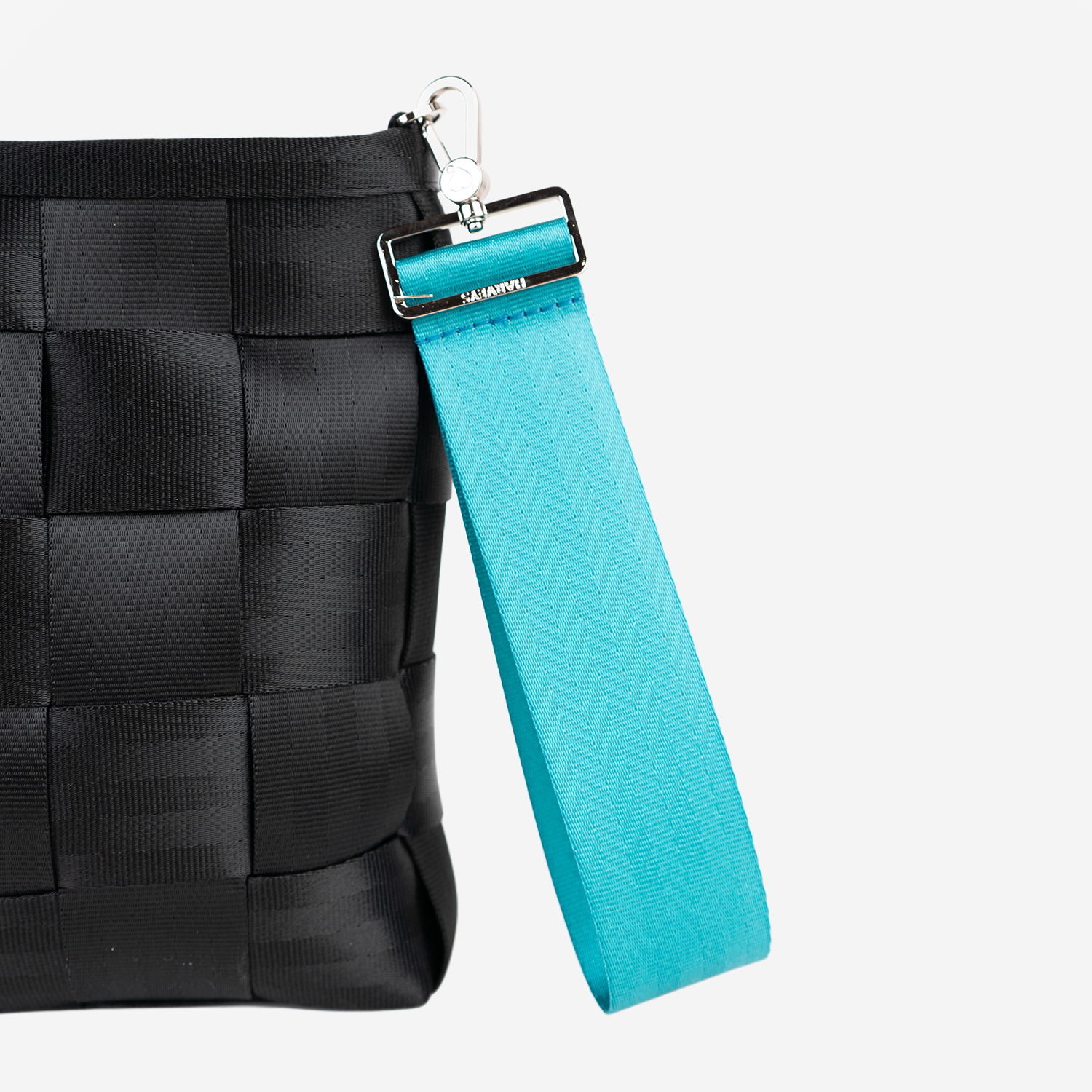 The 5 Panel Keychain in Aqua being used with a bag