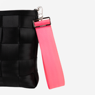 The 5 Panel Keychain in Dragonfruit being used on a bag