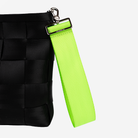 The 5 Panel Keychain in Lime being used on a bag