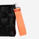 The 5 Panel Keychain in Poppy being used on a bag