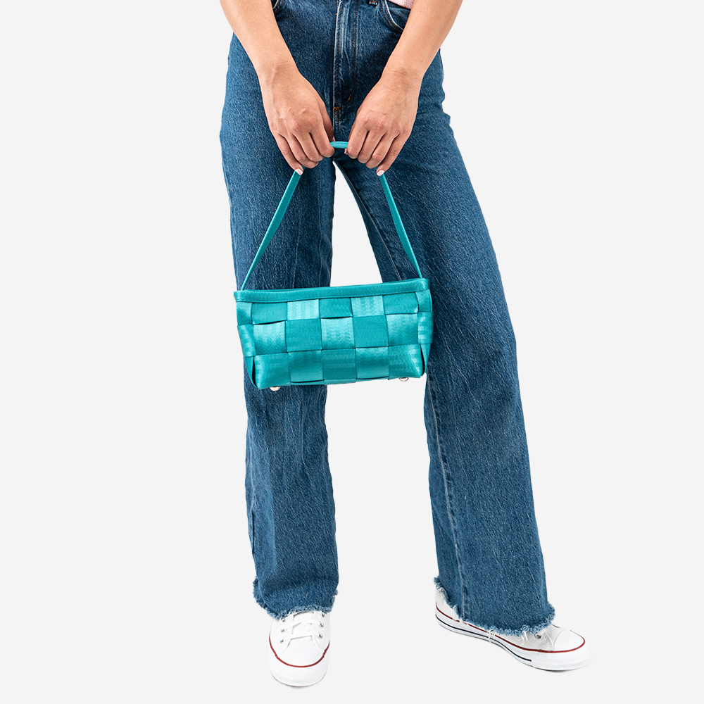 The Baguette in Aqua being held by a model