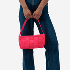 The Baguette in Dragonfruit being held by a model