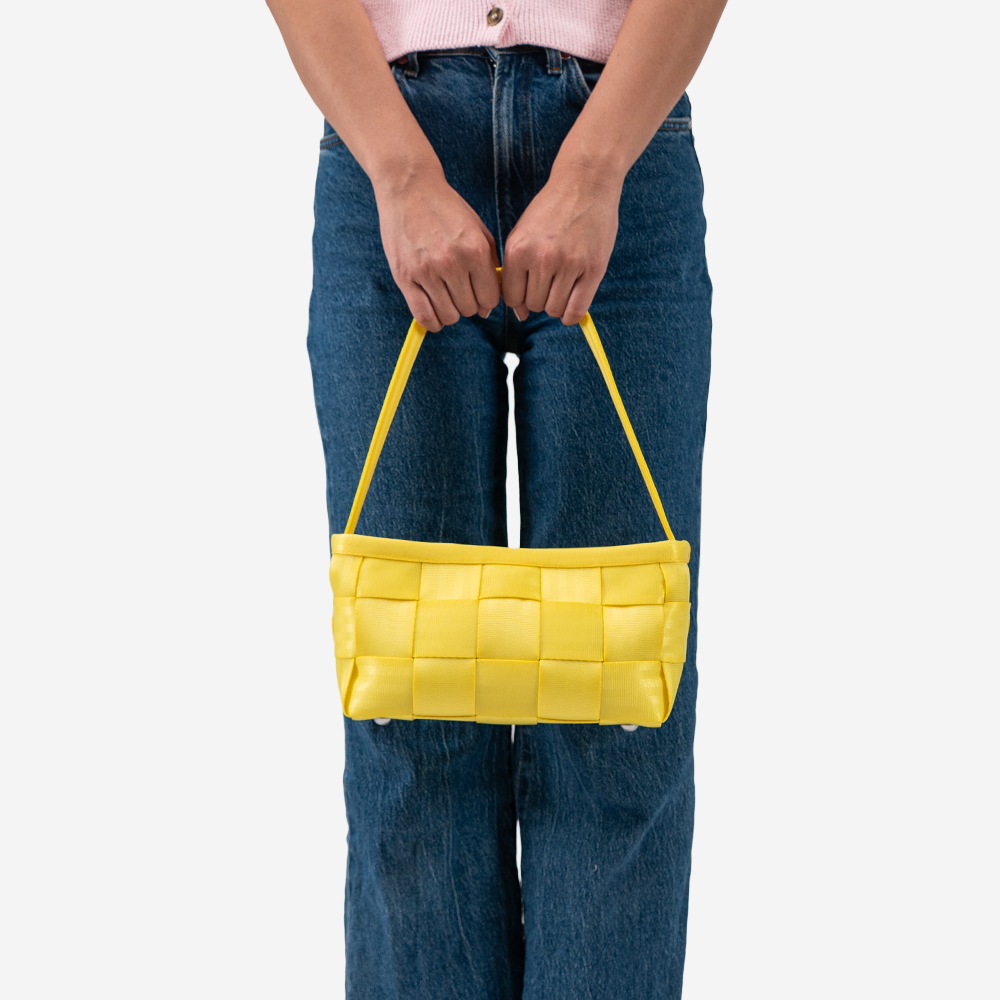 The Baguette in Lemon being held by a model