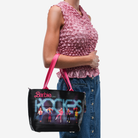 The Barbie And The Rockers Mini Streamline Tote being worn by a model