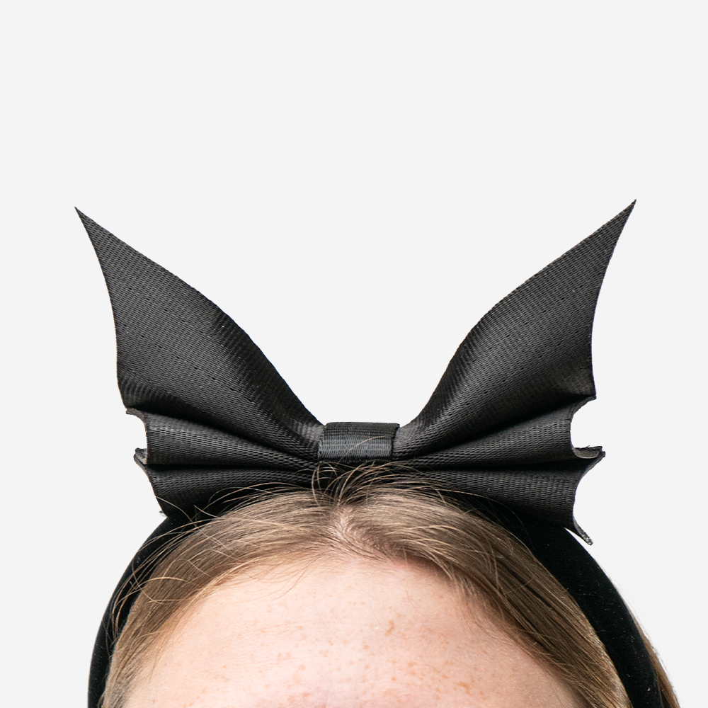 A Bat Headband in Black being worn by a model