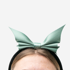 A Bat Headband in Mint being worn by a model