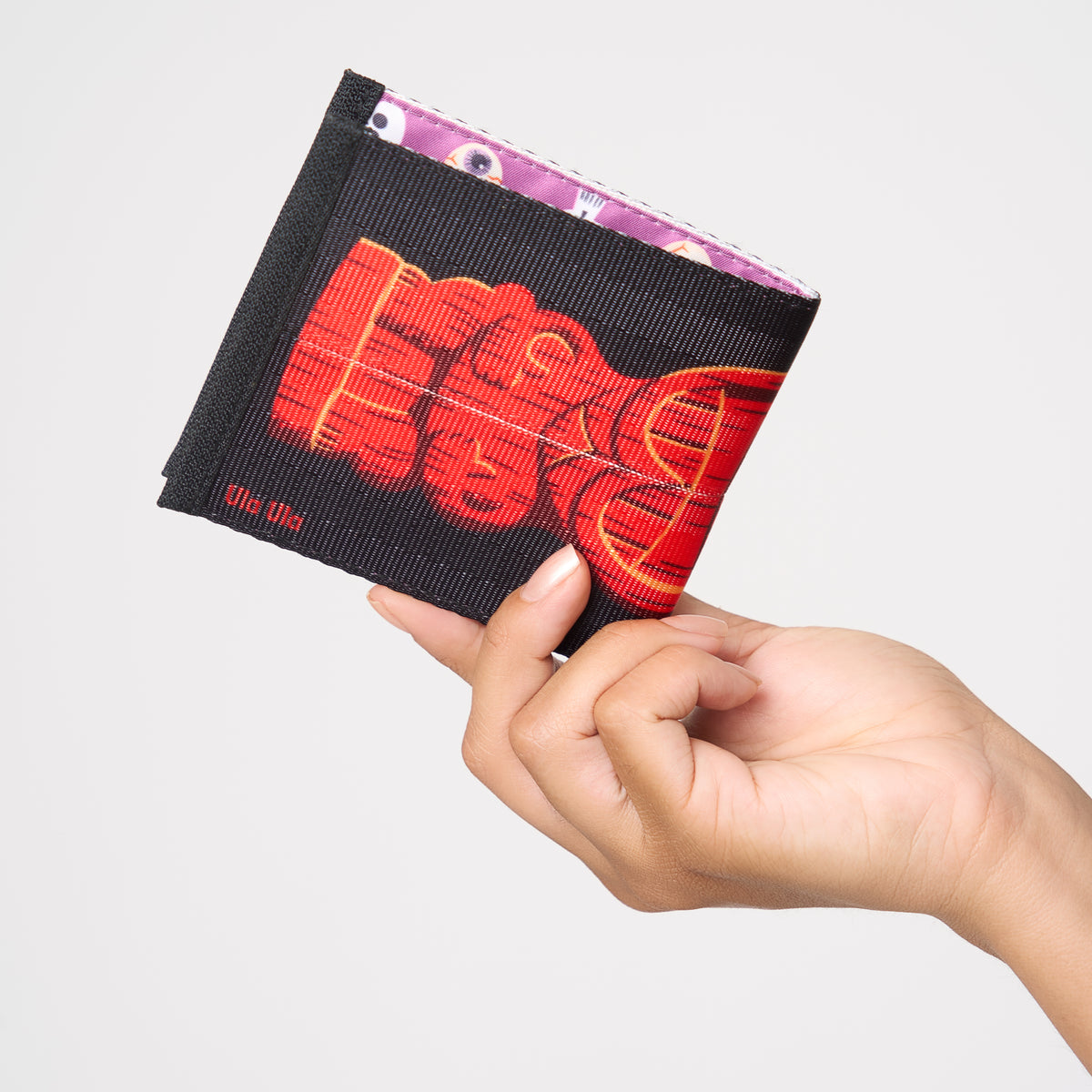 Model holding closed billfold Shag Ula Ula