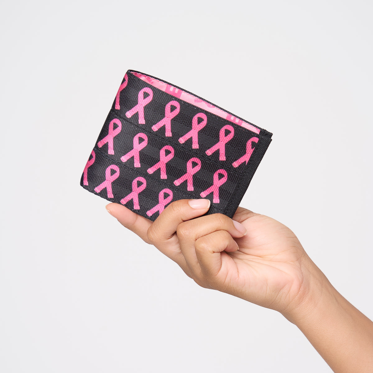 A model holding The Pink Agenda Pink Ribbon Billfold